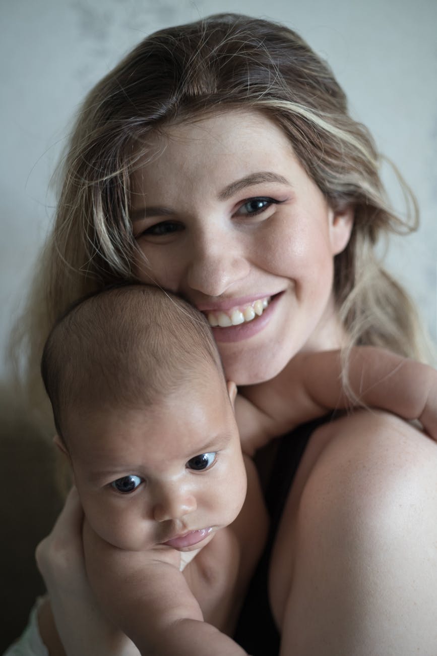 smiling woman holding a baby