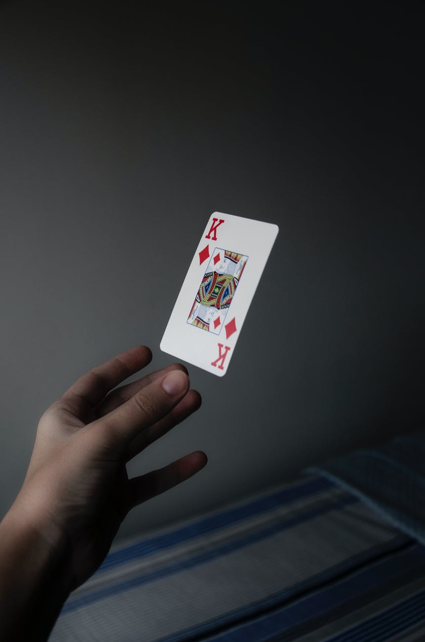 person holding king of diamonds playing card